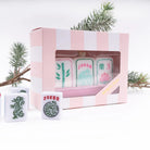 Set of decorative tiles with 'Joker' and number '3' design in a pink striped box, with Christmas trees in the background.