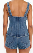 Denim top and shorts set on a plain background
