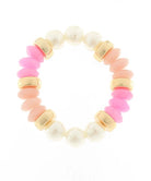 Bracelet with pink and white beads and gold accents on a white background