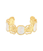 A gold-toned cuff bracelet featuring organic-shaped white iridescent opal inlays, photographed on a solid white background.