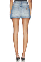 Denim skirt worn by a person on a white background