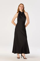 Woman wearing a black halter neck dress on a white background