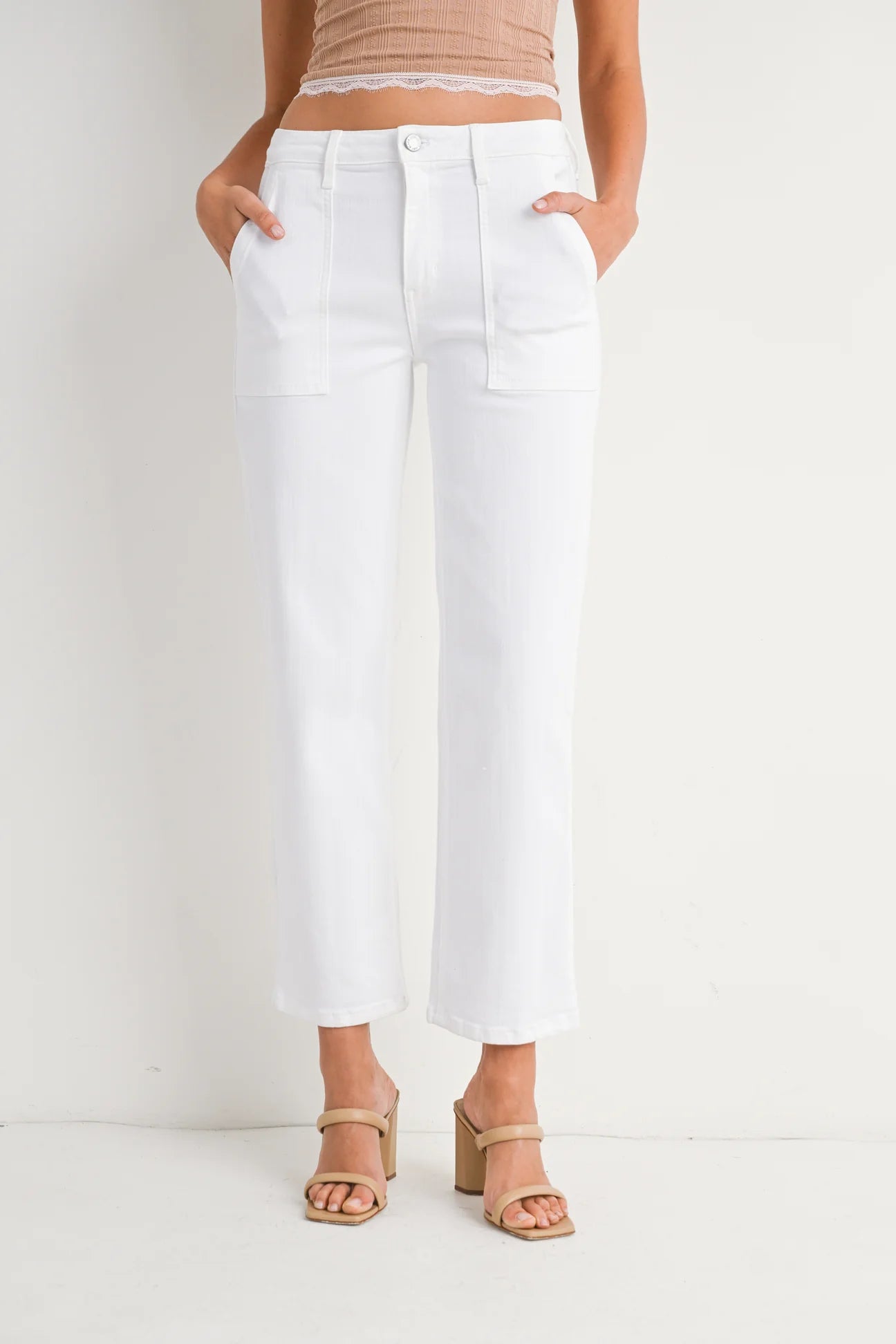 Person wearing white pants on a plain background