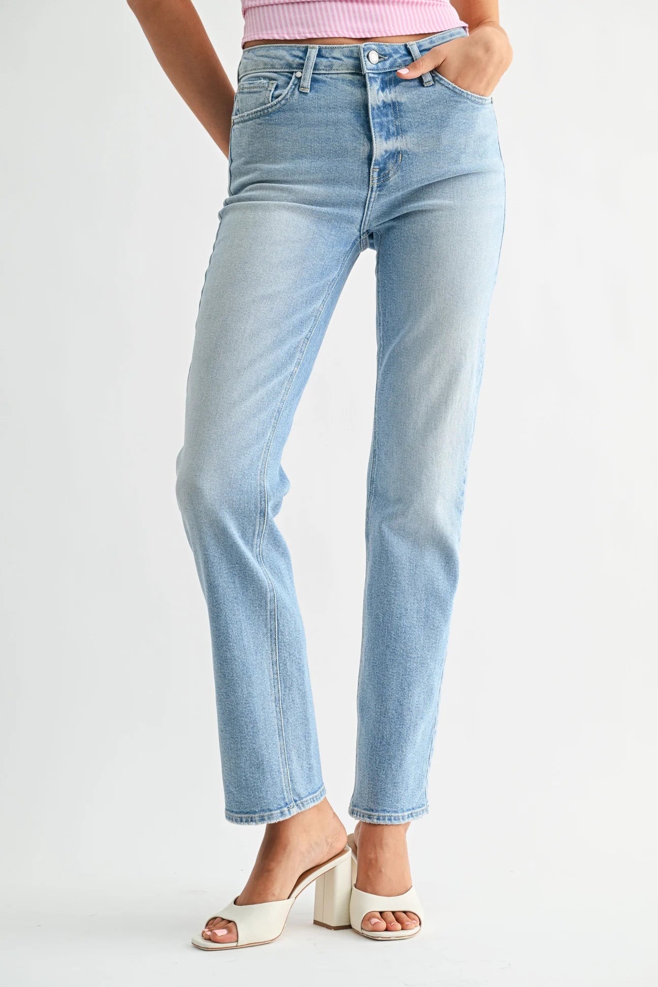 Light blue jeans worn by a person on a white background