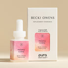 Becki Owens Pineapple Sunrise fragrance refill bottle and packaging on a beige background