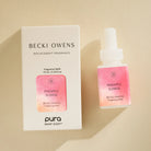Becki Owens Pineapple Sunrise fragrance refill bottle and packaging on a beige background