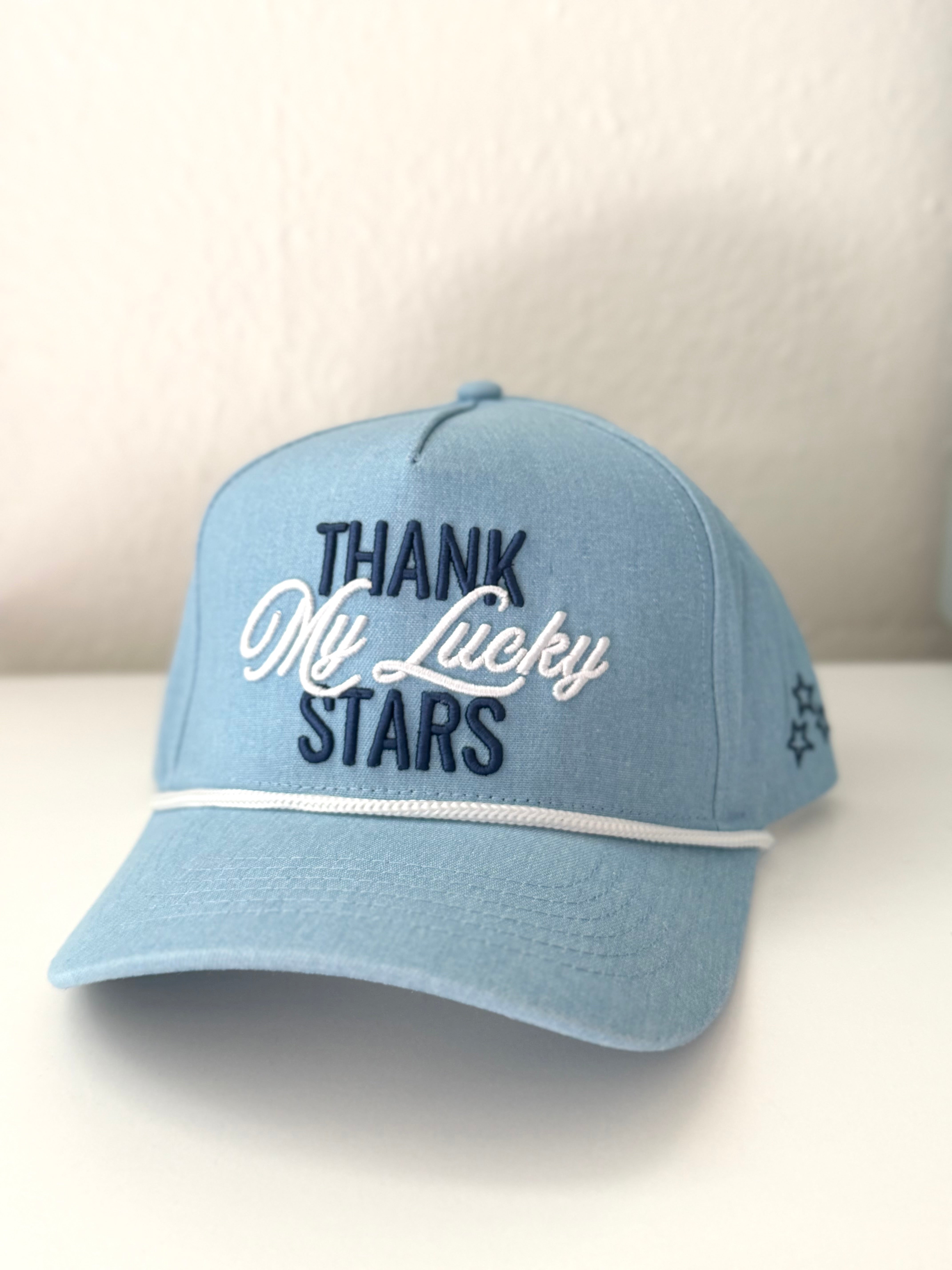 Light blue cap with 'Thank My Lucky Stars' text on a white background