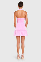 Pink strapless dress worn by a model on a light gray background