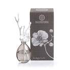 Decorative diffuser with floral design and matching box on a white background