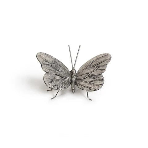 Metallic butterfly sculpture on a white background