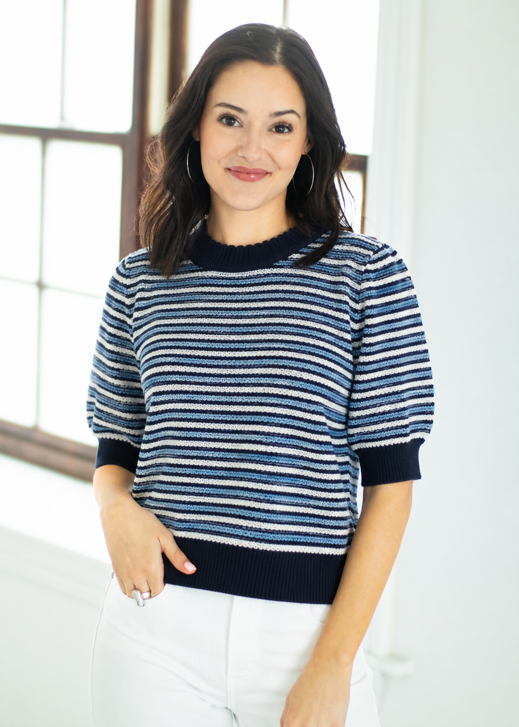 Woman wearing a blue and white striped sweater indoors