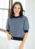 Woman wearing a blue and white striped sweater indoors