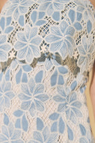 Close-up of a lace garment with blue floral patterns