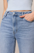 Close-up of blue jeans with a neutral background