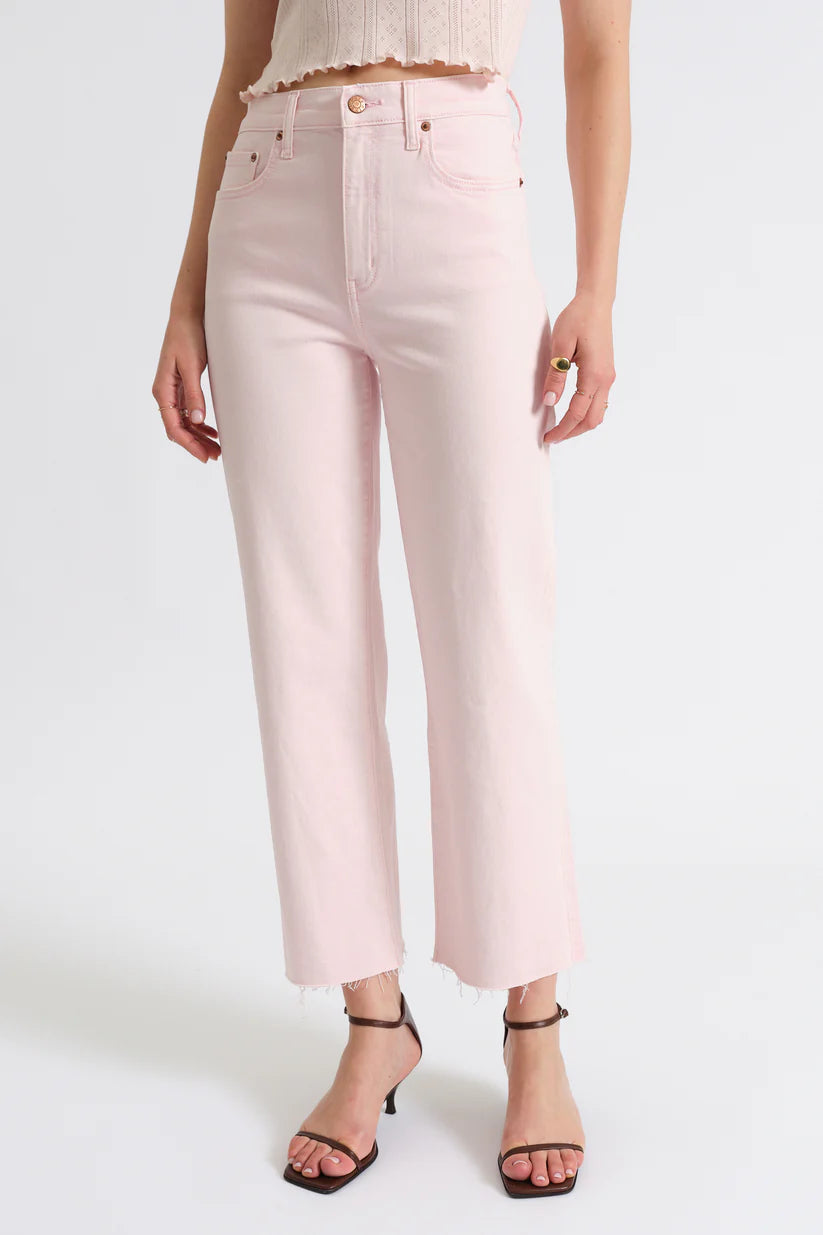 Light pink jeans worn by a person on a white background