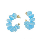 Pair of blue beaded hoop earrings on a white background