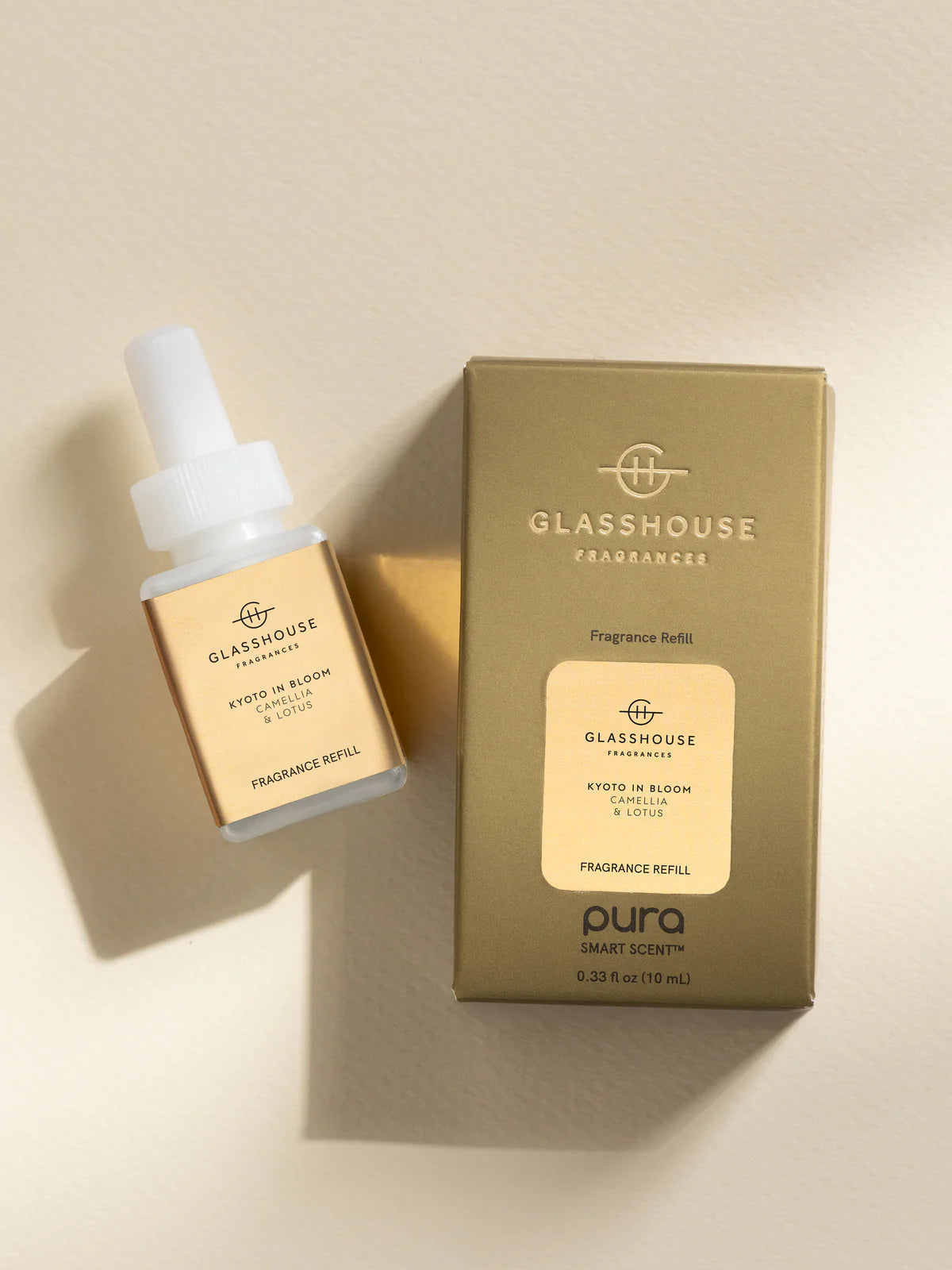 Glasshouse Fragrances Pura refill bottle and packaging on a beige background