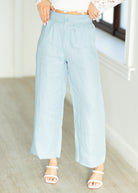 Light blue wide-leg pants worn by a person indoors.