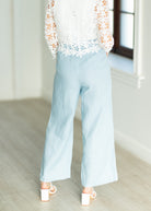 Light blue pants worn by a person in a minimal indoor setting