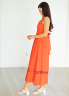 Woman wearing an orange dress with a white background