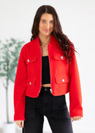 Woman wearing a red jacket with a blurred background