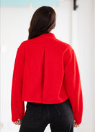 Person wearing a red jacket with a white background