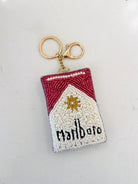 A beaded keychain shaped like a Marlboro cigarette pack, featuring red and white beadwork with a gold-tone metal clasp on a plain white background.