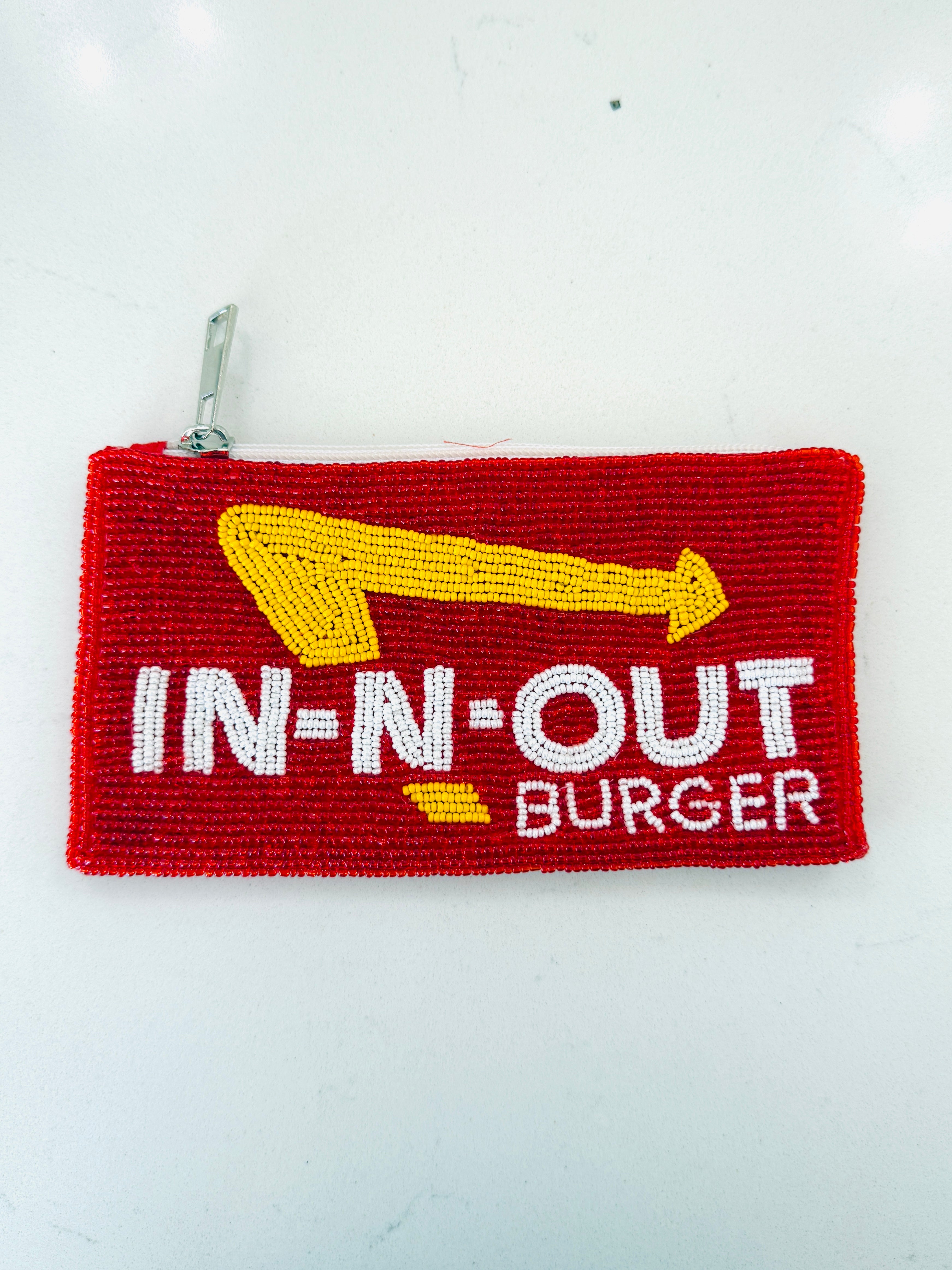 A red woven pouch featuring the yellow and white 'IN-N-OUT BURGER' logo, with a silver zipper pull, photographed on a white background.