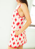 Red and white patterned dress worn by a person on a blurred background