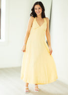 Woman wearing a yellow dress against a white background