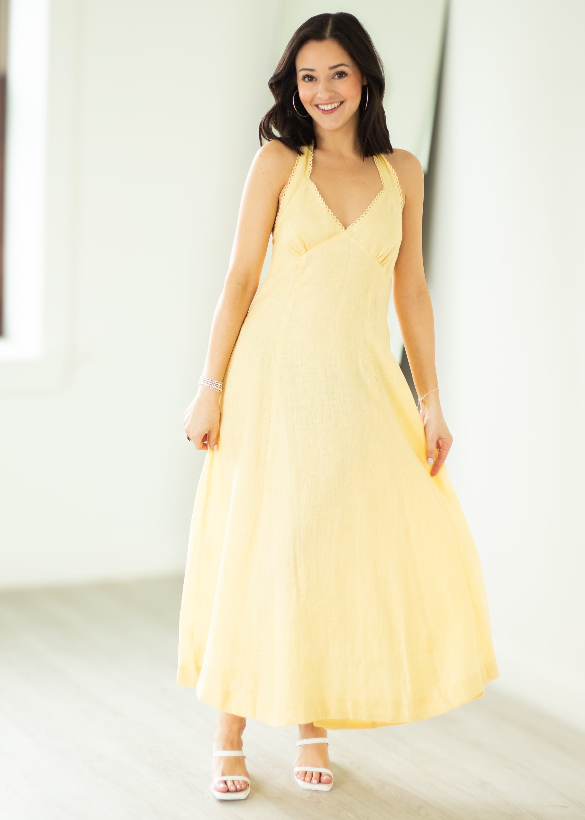 Woman wearing a yellow dress against a white background