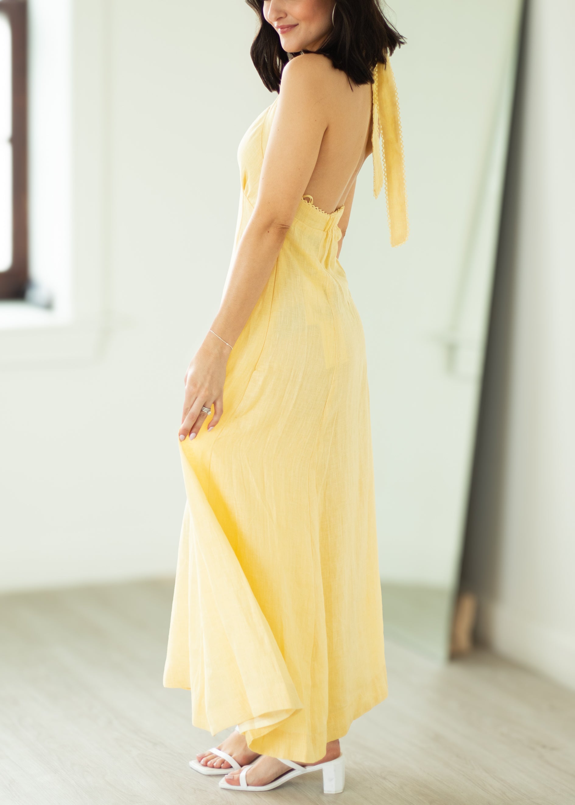 Woman wearing a yellow dress with a blurred background
