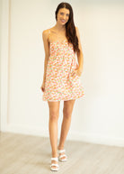 Woman wearing a floral dress against a white background