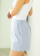 Light blue shorts worn by a person against a neutral background