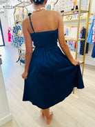 Woman wearing a blue dress in a store setting