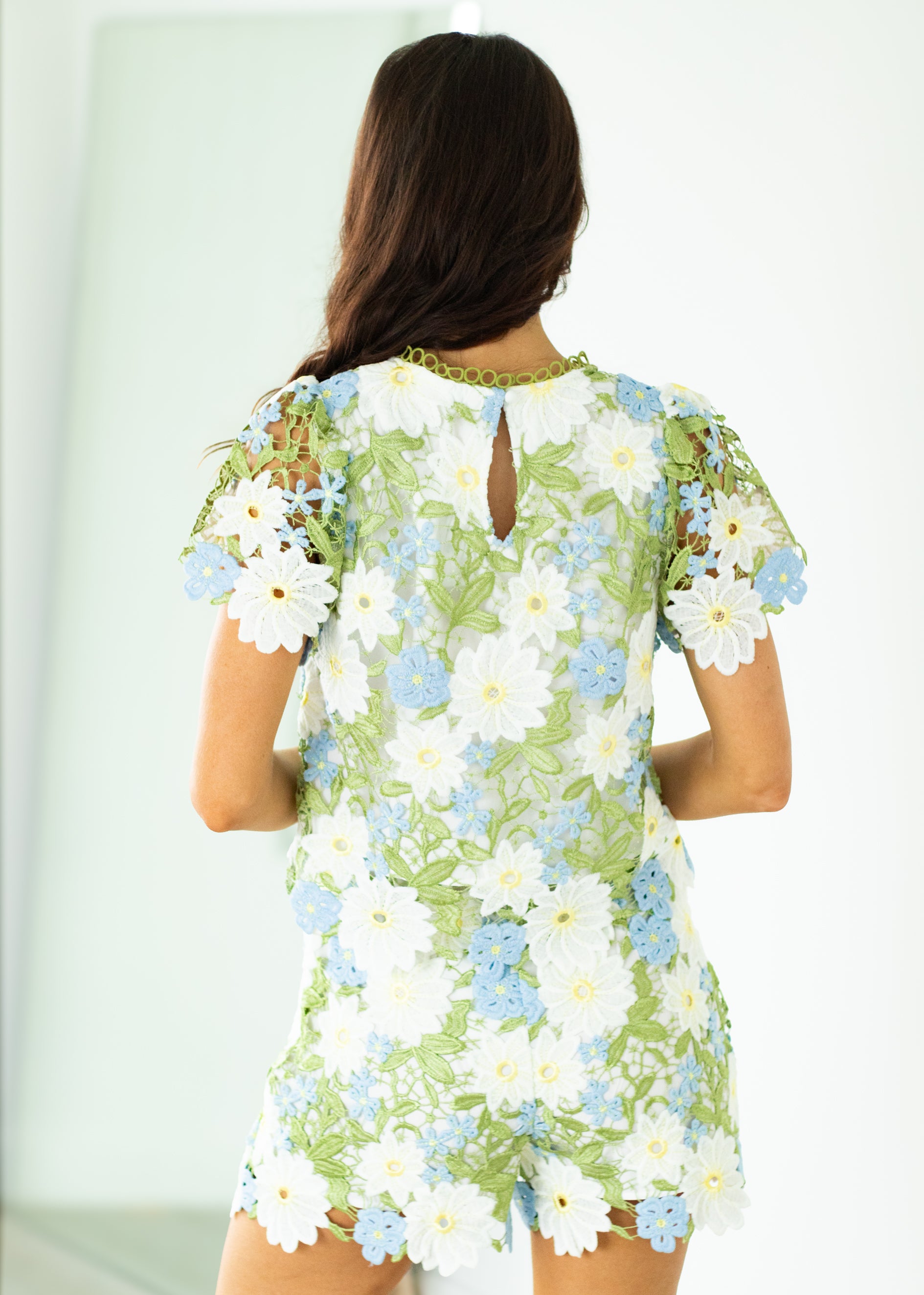Woman wearing a floral outfit with a white background