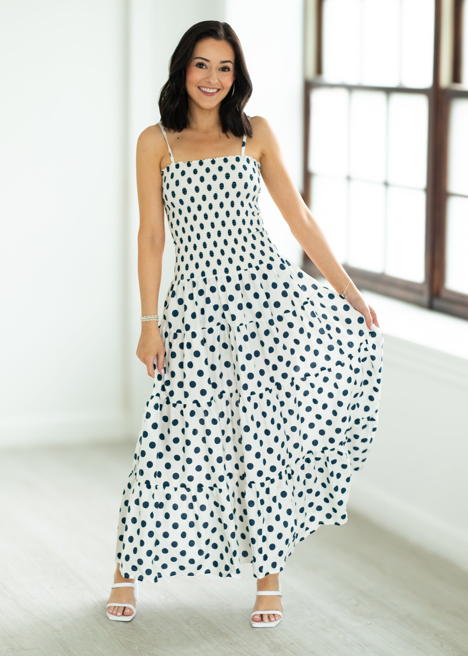 Woman wearing a polka dot dress in a bright room