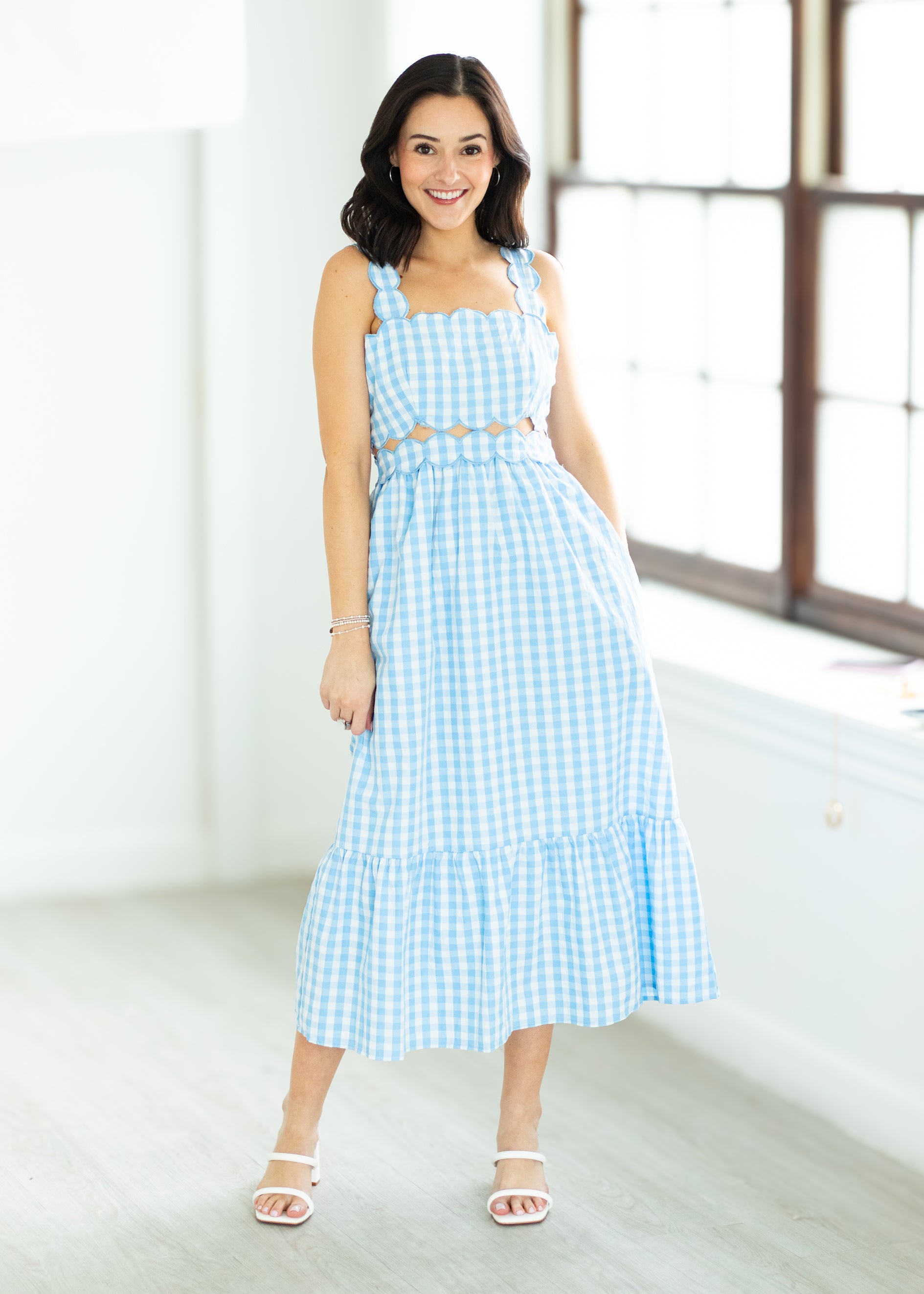 Woman wearing a blue checkered dress 

