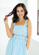 Woman wearing a blue checkered dress 
