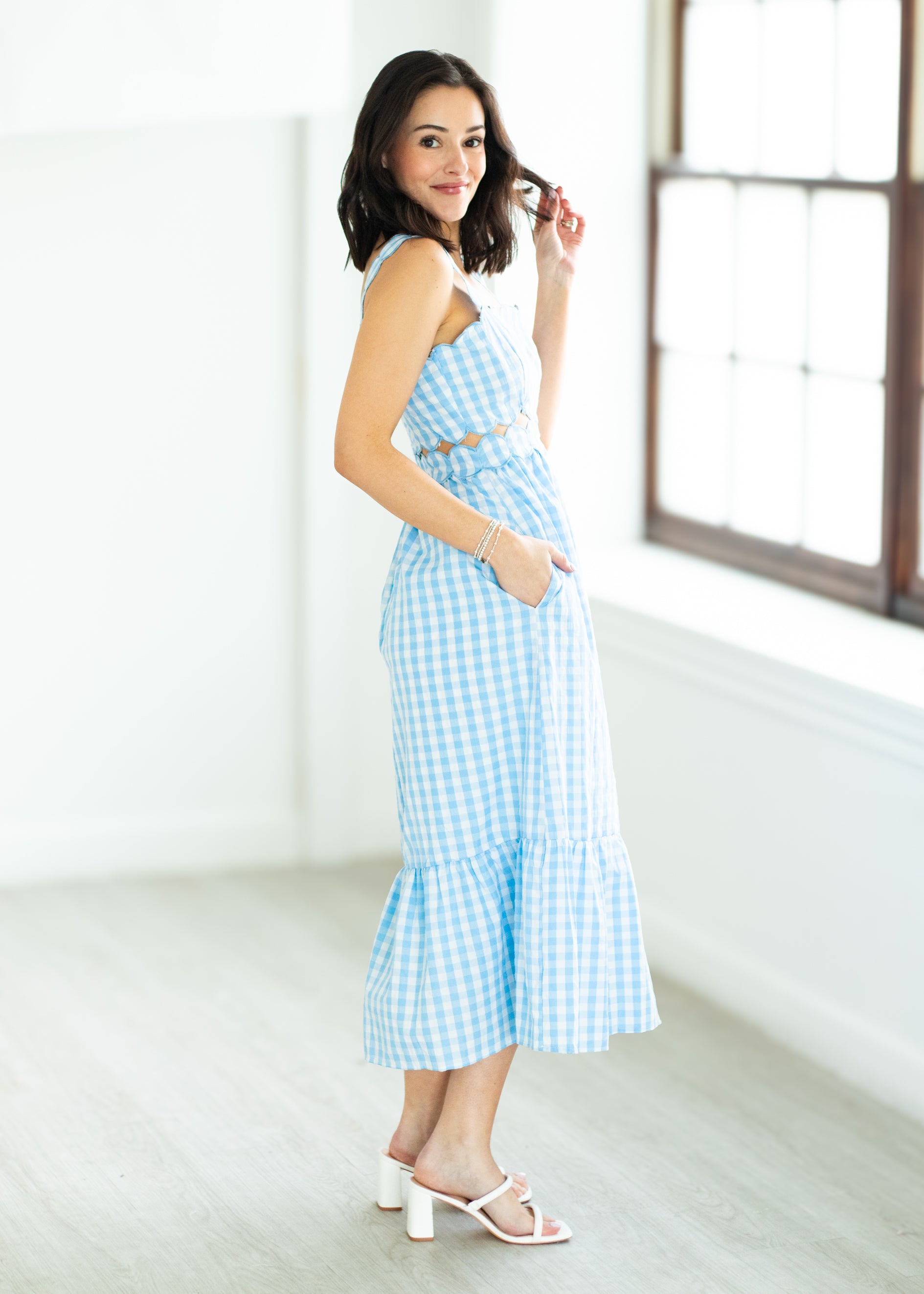 Woman wearing a blue checkered dress 
