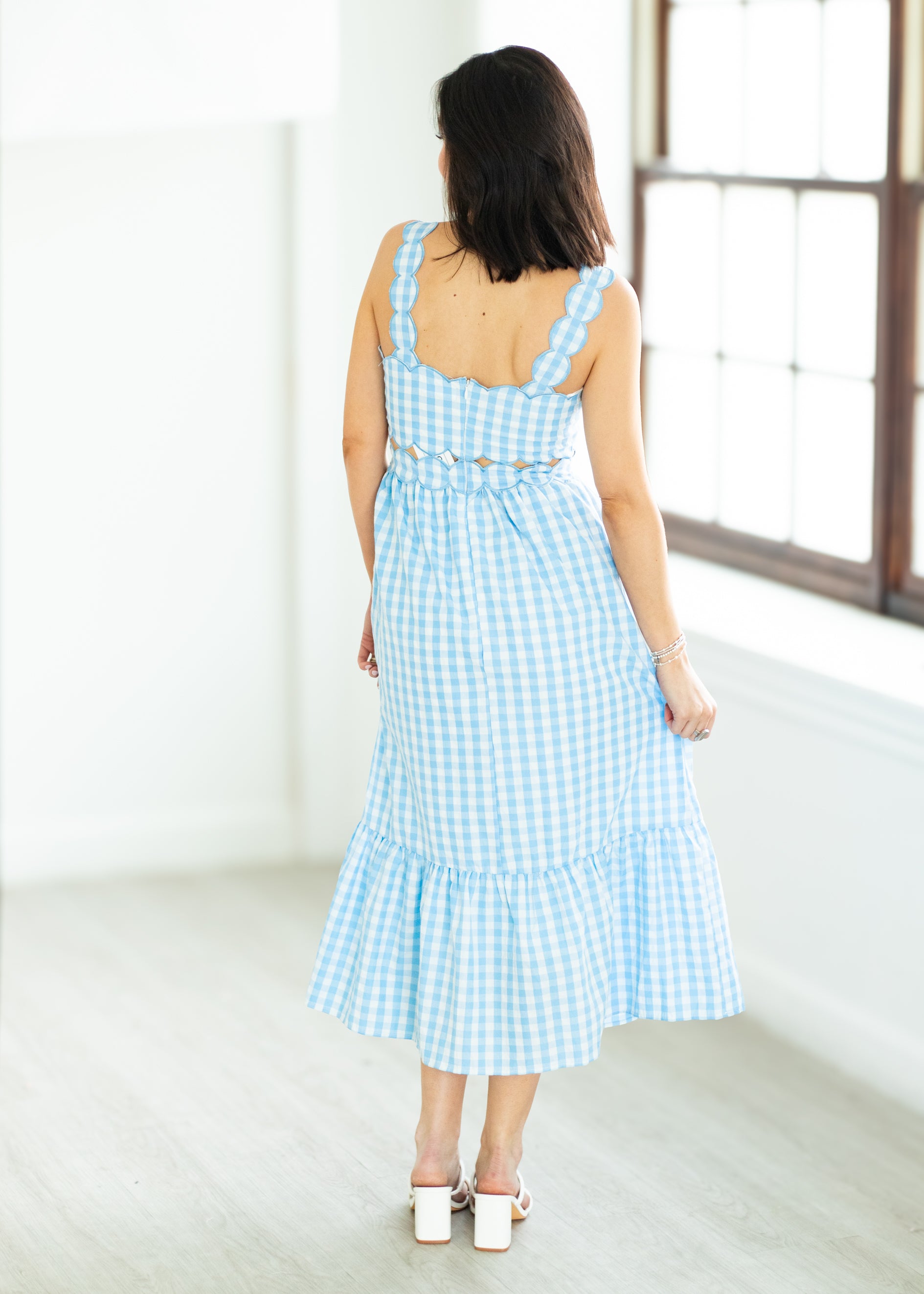 Woman wearing a blue checkered dress 
