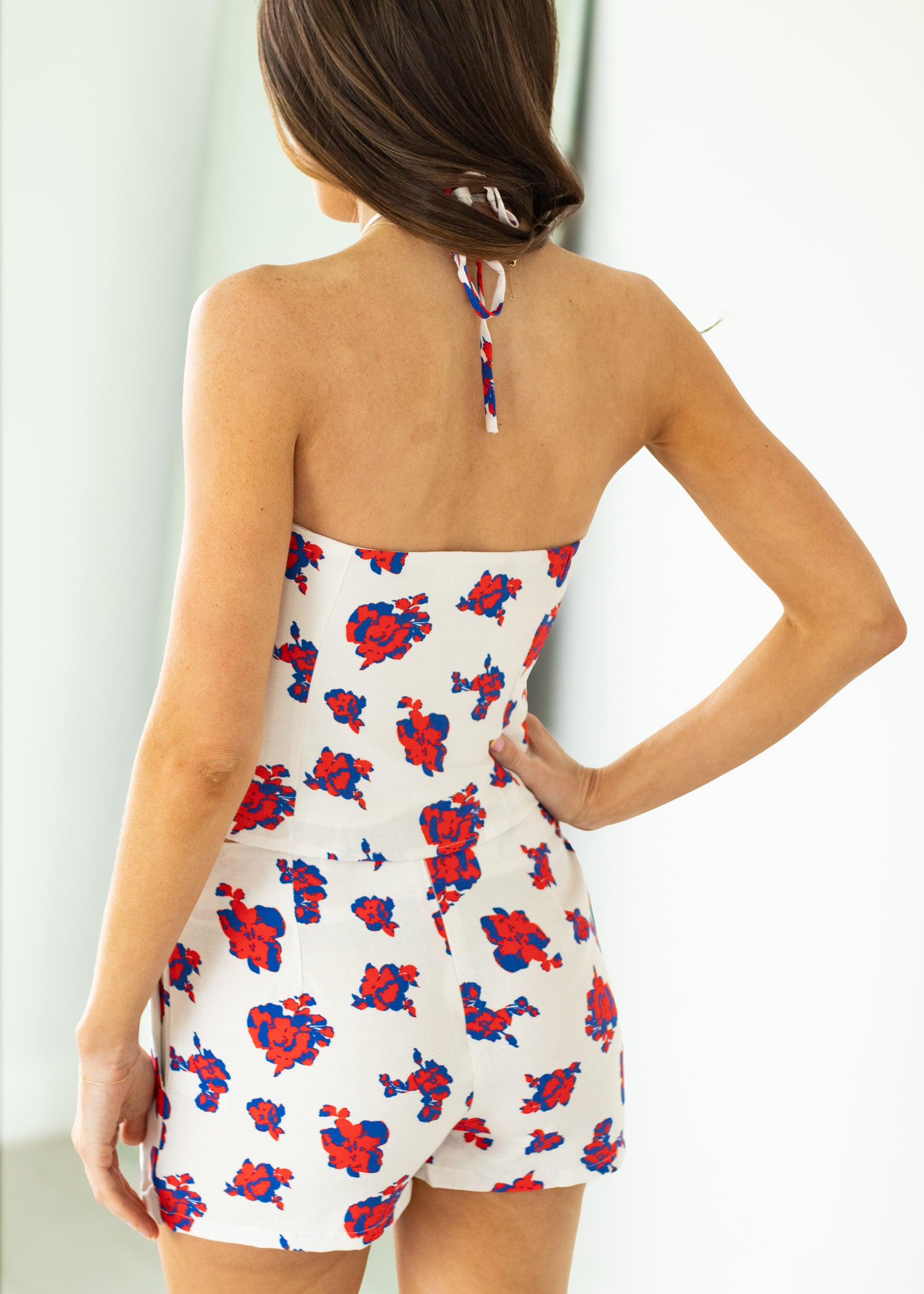 Woman wearing a floral set with a white background
