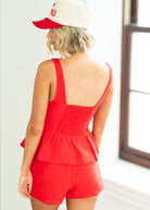 woman wearing red top in a bright room.