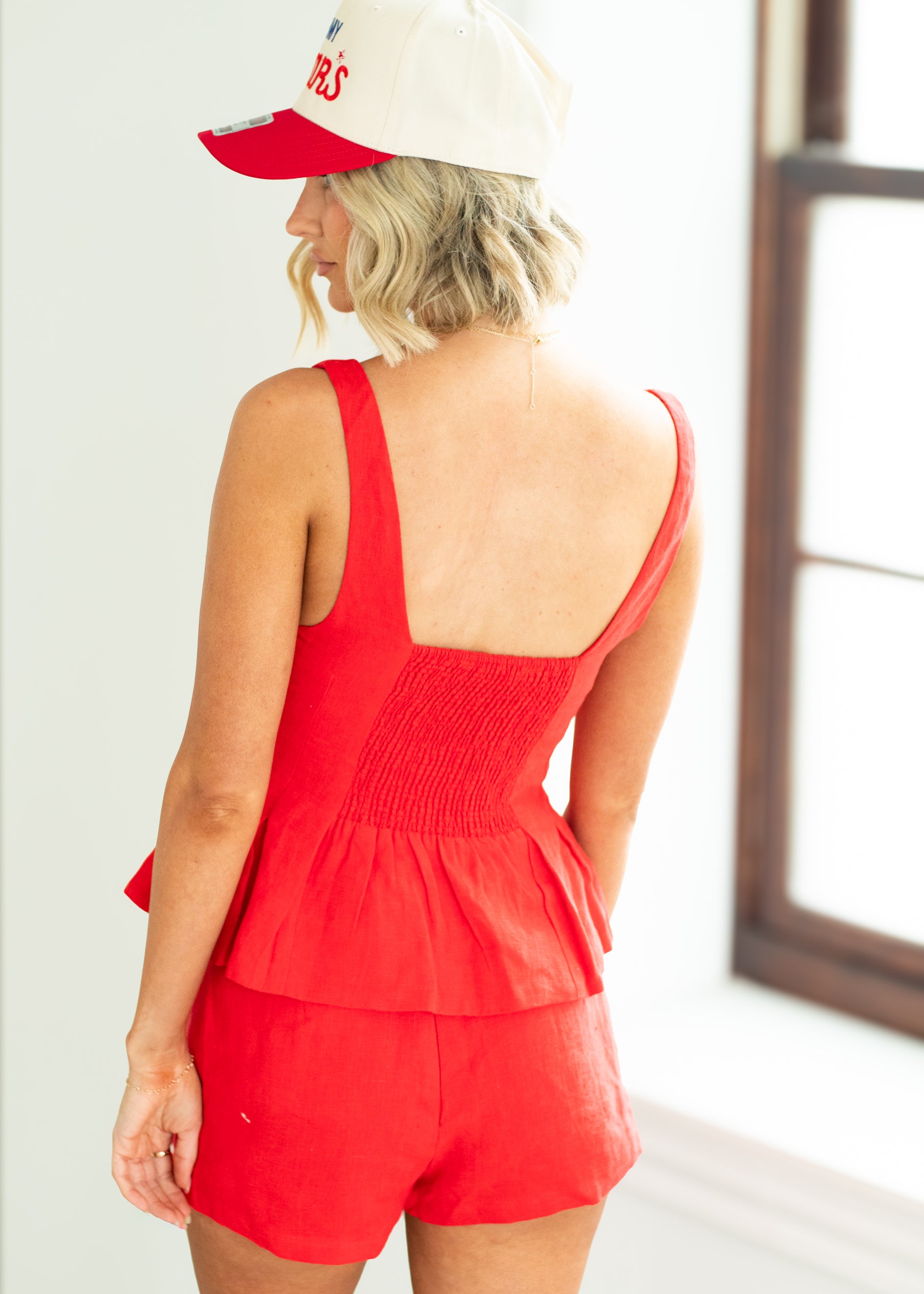woman wearing red top in a bright room.
