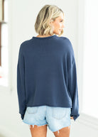 woman wearing navy sweater