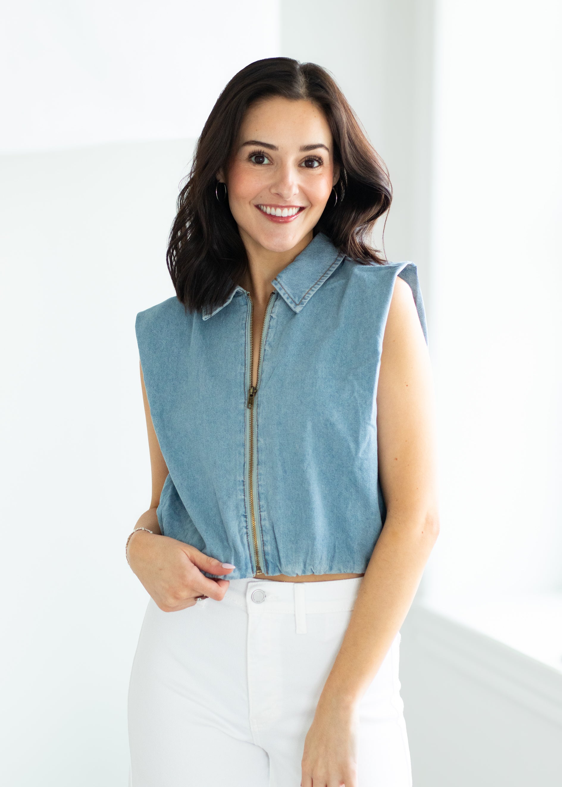 woman wearing a denim vest
