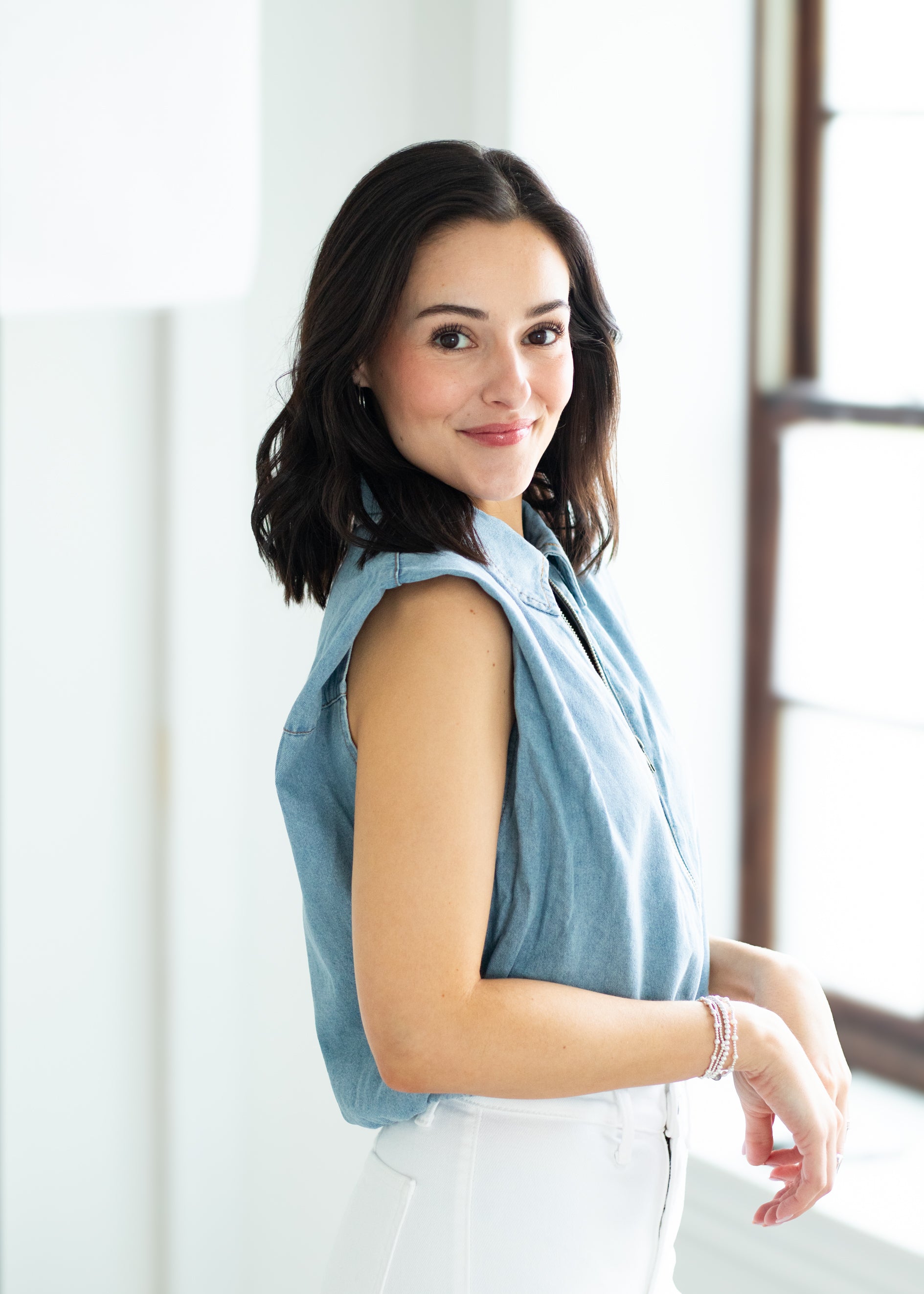 woman wearing a denim vest
