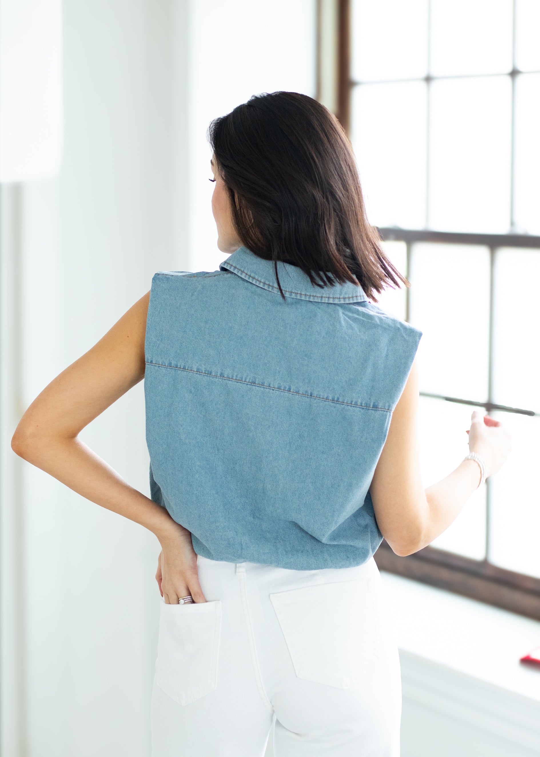woman wearing a denim vest
