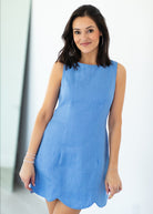 Woman wearing a blue dress against a white background