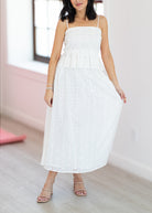 Woman wearing a white dress with a blurred background